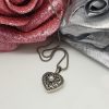 Pendente a cuore apribile con perla coltivata e marcassiti griffate, corredato di catena brunita e diamantata.  PD0465